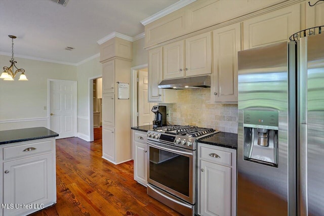 kitchen featuring tasteful backsplash, ornamental molding, appliances with stainless steel finishes, under cabinet range hood, and dark wood-style floors