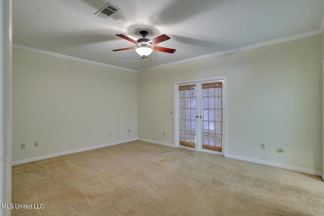 empty room featuring ceiling fan, light carpet, french doors, ornamental molding, and visible vents
