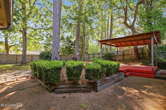 view of yard with a wooden deck and a fenced backyard
