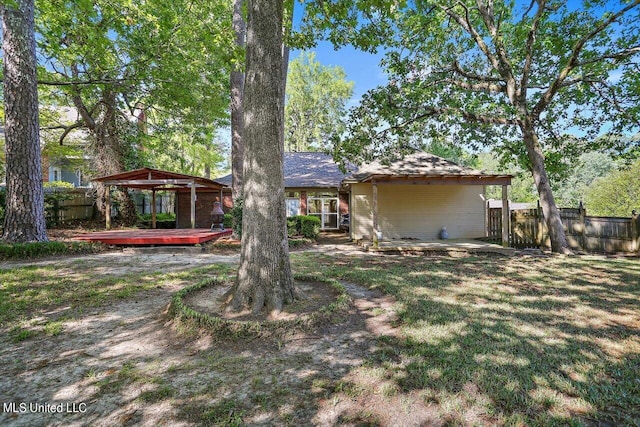 back of house featuring fence and a wooden deck