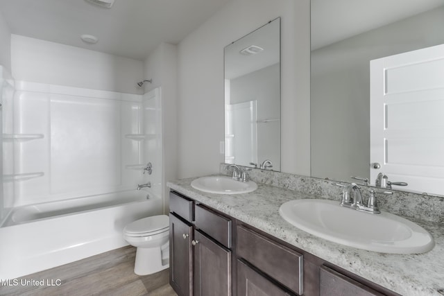 2016 Carondelet St, Ocean Springs, MS 39564 - full bathroom featuring double vanity, wood finished floors, and shower / bathtub combination