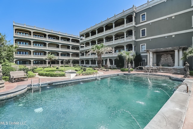 view of swimming pool featuring pool water feature