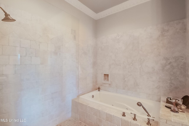 bathroom with tiled shower / bath and tile walls