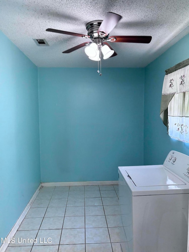 laundry room featuring ceiling fan, washer / clothes dryer, a textured ceiling, and light tile patterned floors