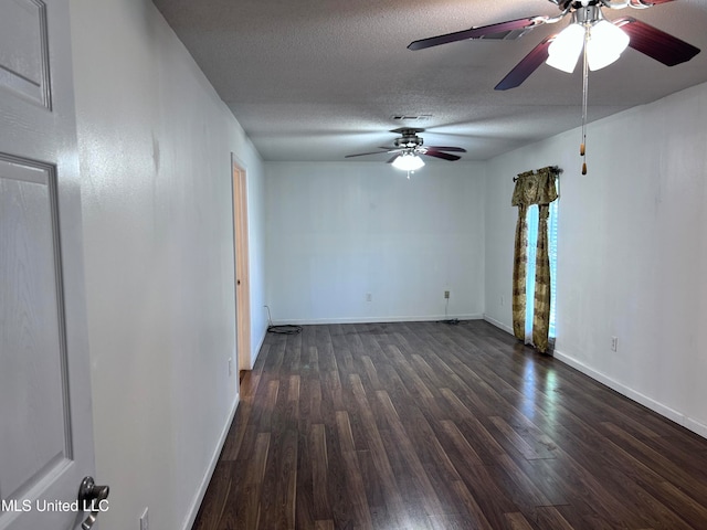 unfurnished room featuring ceiling fan, a textured ceiling, and dark hardwood / wood-style flooring