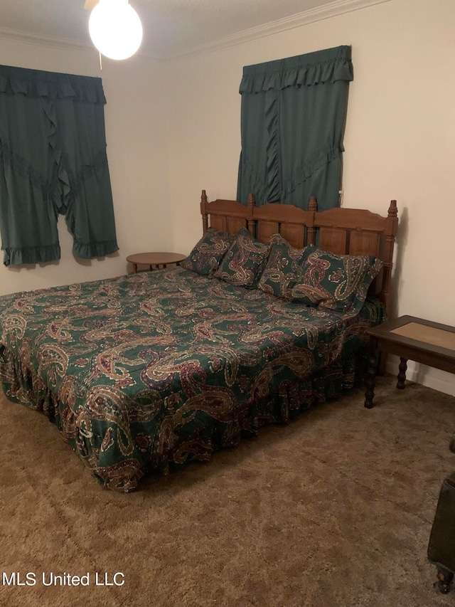 bedroom featuring crown molding and carpet floors