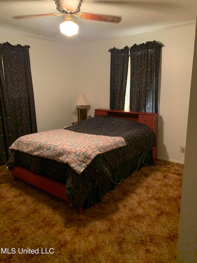 bedroom featuring crown molding, carpet floors, a textured ceiling, and ceiling fan