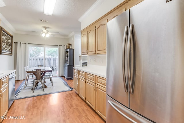 8921 Hanalei Cir, Diamondhead, MS 39525 - kitchen with stainless steel appliances, light wood-style flooring, light countertops, ceiling fan, and light brown cabinetry
