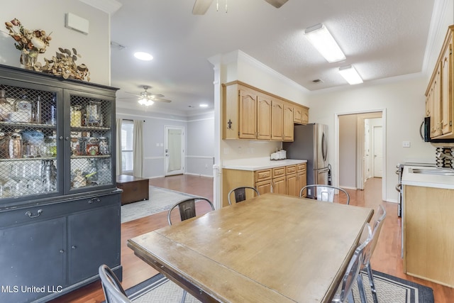 8921 Hanalei Cir, Diamondhead, MS 39525 - dining room featuring a ceiling fan, wood finished floors, crown molding, and recessed lighting