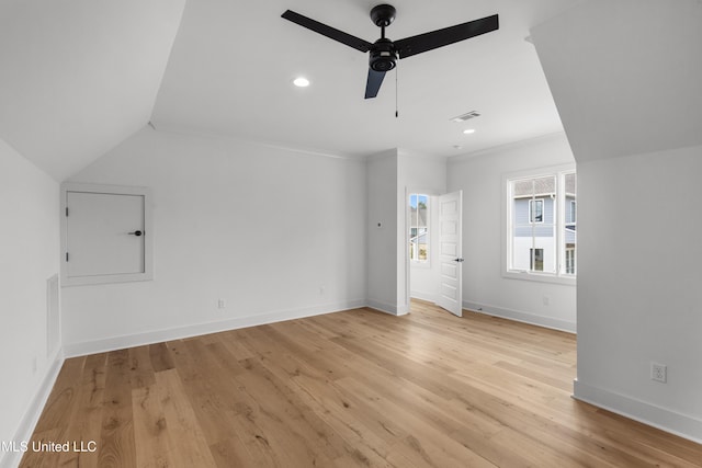 interior space featuring ceiling fan, light wood-style flooring, visible vents, and baseboards