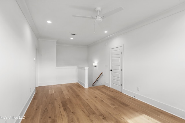 empty room featuring baseboards, ceiling fan, crown molding, light wood-style floors, and recessed lighting