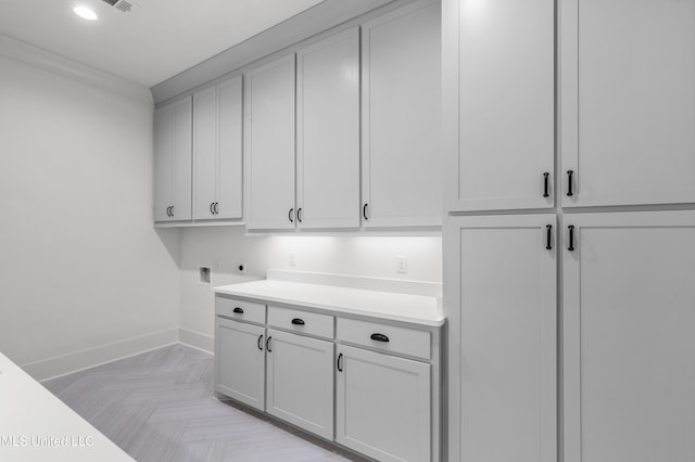 laundry room with washer hookup, cabinet space, electric dryer hookup, and baseboards