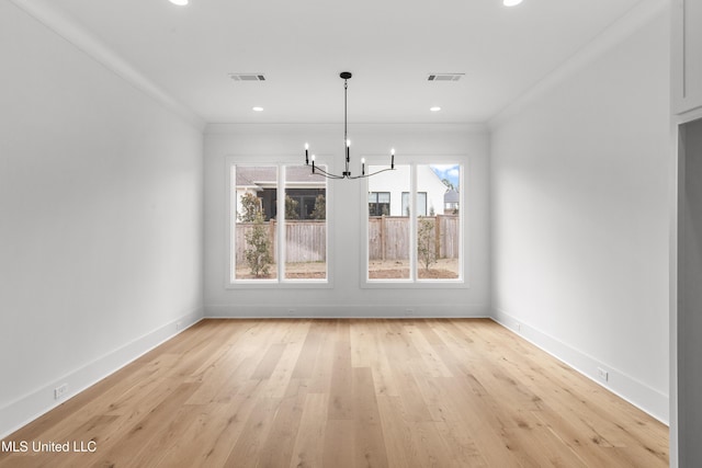 unfurnished dining area with light wood-type flooring, visible vents, crown molding, and baseboards