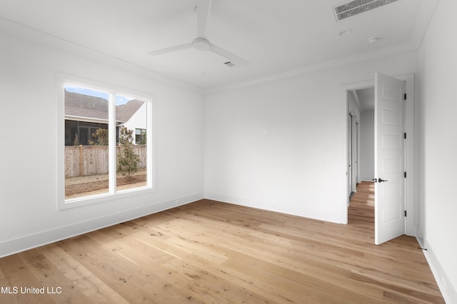 unfurnished room with light wood-style floors, visible vents, baseboards, and a ceiling fan