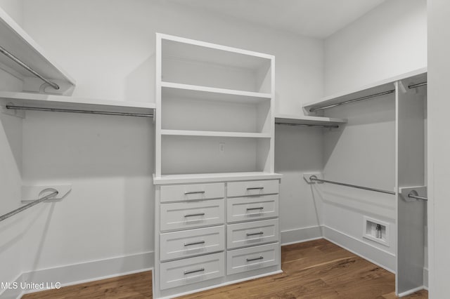 walk in closet featuring dark wood-style flooring