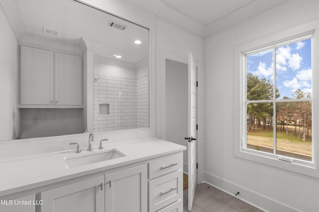 bathroom with visible vents, recessed lighting, vanity, and baseboards