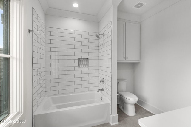 bathroom featuring toilet, baseboards, visible vents, and shower / bathing tub combination