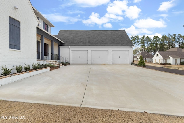 view of home's exterior featuring driveway, an attached garage, and a residential view