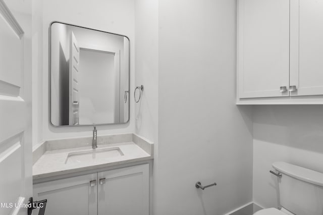 bathroom featuring toilet and vanity