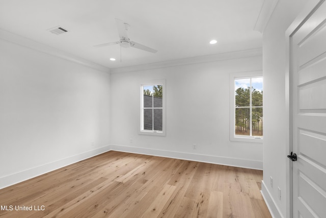 empty room featuring light wood finished floors, baseboards, visible vents, ornamental molding, and recessed lighting