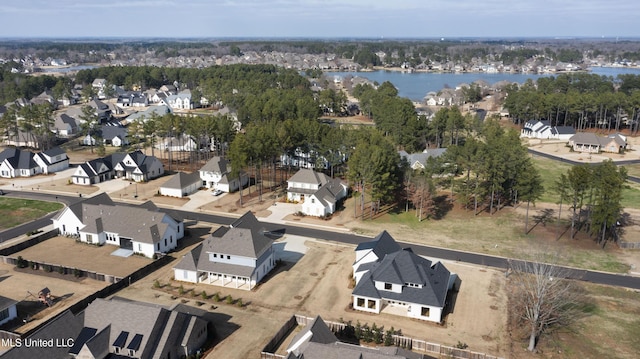 birds eye view of property with a water view and a residential view