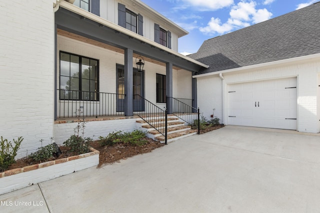 view of front of house featuring a garage, roof with shingles, concrete driveway, and brick siding