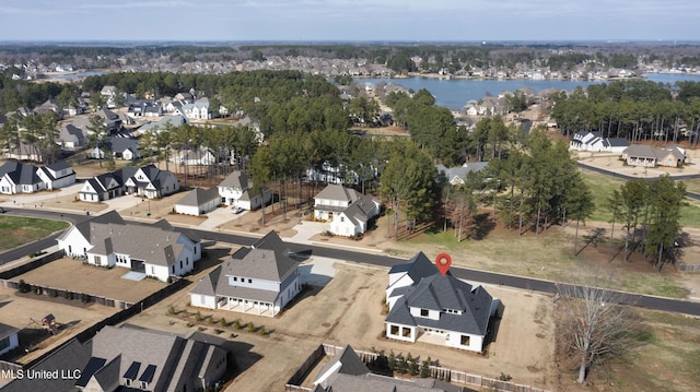 birds eye view of property with a residential view and a water view