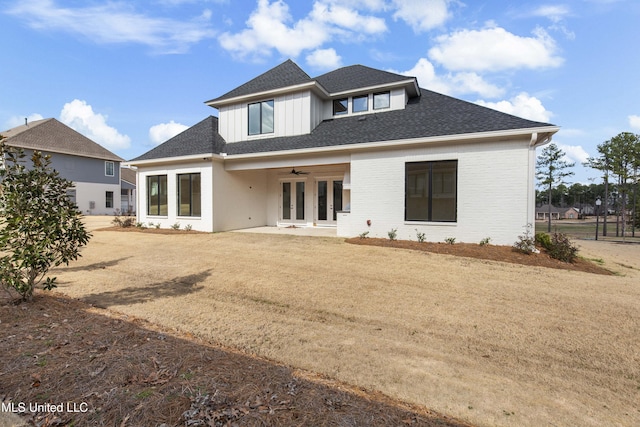 back of property featuring brick siding, a yard, a patio, a shingled roof, and a ceiling fan