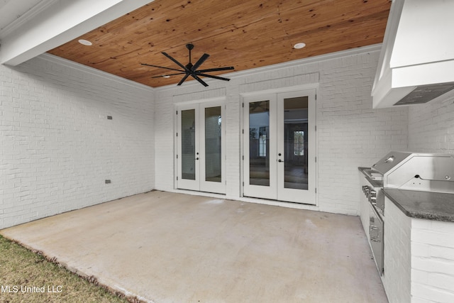 view of patio featuring ceiling fan, french doors, area for grilling, and exterior kitchen