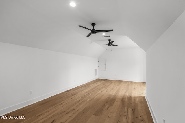 bonus room featuring a ceiling fan, visible vents, vaulted ceiling, baseboards, and light wood-type flooring