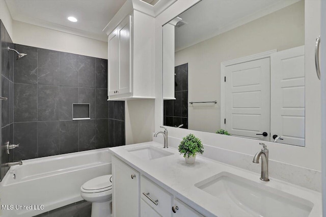 full bathroom featuring tiled shower / bath, vanity, and toilet