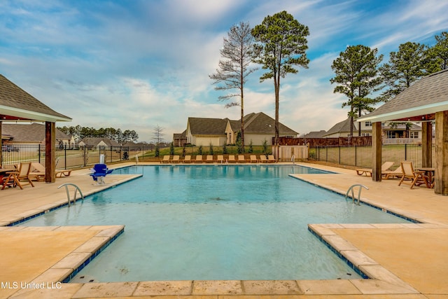 community pool featuring a patio, a gazebo, and fence