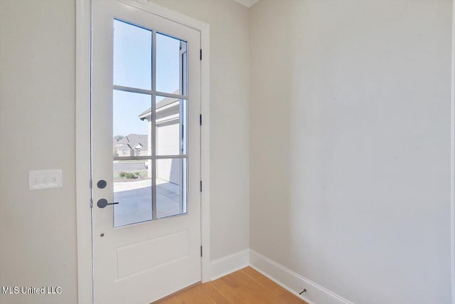 entryway with baseboards and light wood-type flooring