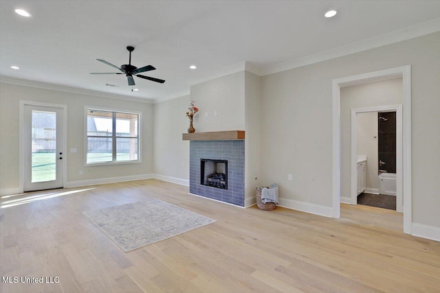 unfurnished living room with ornamental molding, light wood-type flooring, and ceiling fan