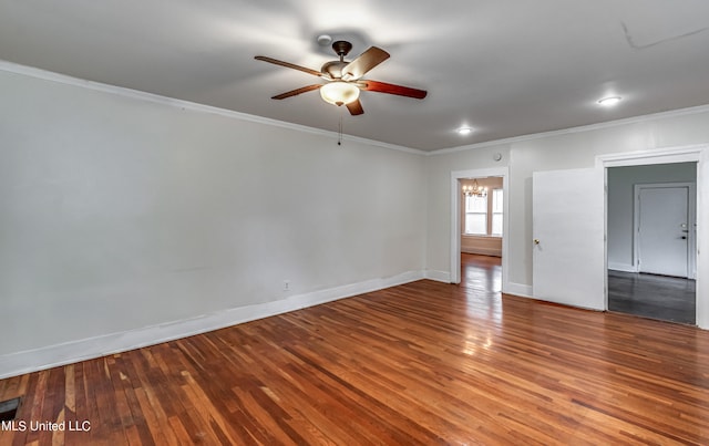 spare room with ornamental molding, ceiling fan with notable chandelier, and hardwood / wood-style floors