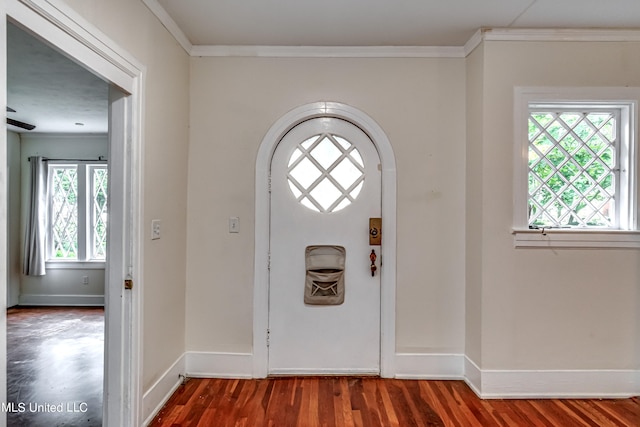 entryway with dark wood-type flooring and crown molding