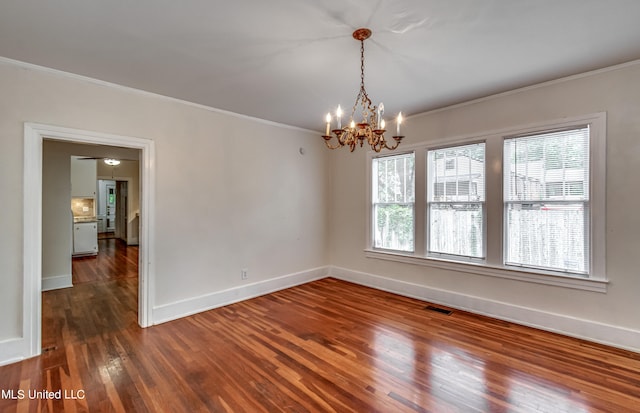 unfurnished room with ornamental molding, a chandelier, and hardwood / wood-style floors