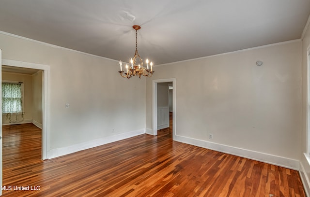 empty room with crown molding, wood-type flooring, and a chandelier