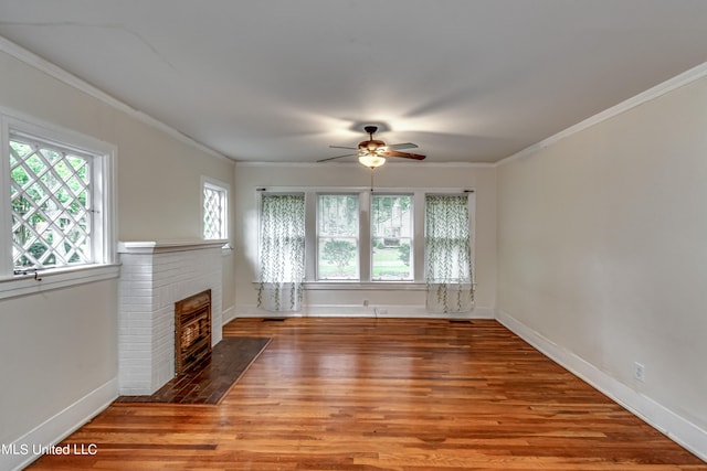 unfurnished living room featuring ornamental molding, a fireplace, light hardwood / wood-style floors, and ceiling fan