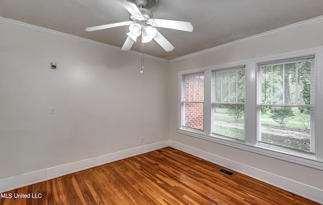 spare room featuring ceiling fan, ornamental molding, plenty of natural light, and hardwood / wood-style floors