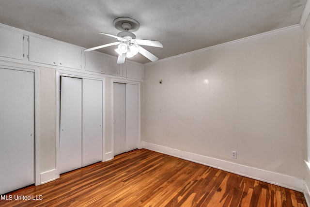 unfurnished bedroom featuring crown molding, ceiling fan, and dark hardwood / wood-style flooring