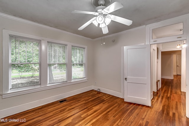 empty room featuring ornamental molding, hardwood / wood-style floors, plenty of natural light, and ceiling fan