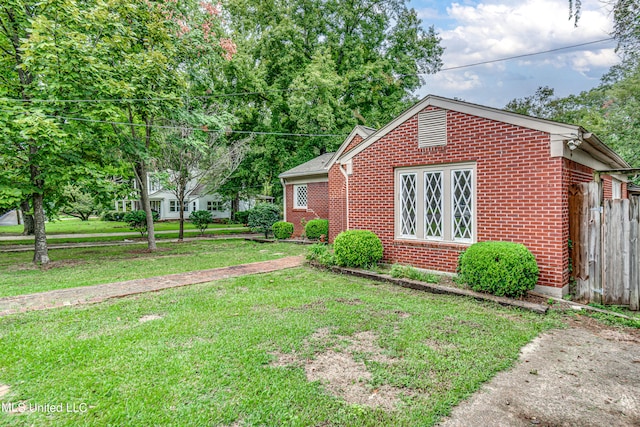 view of property exterior featuring a lawn