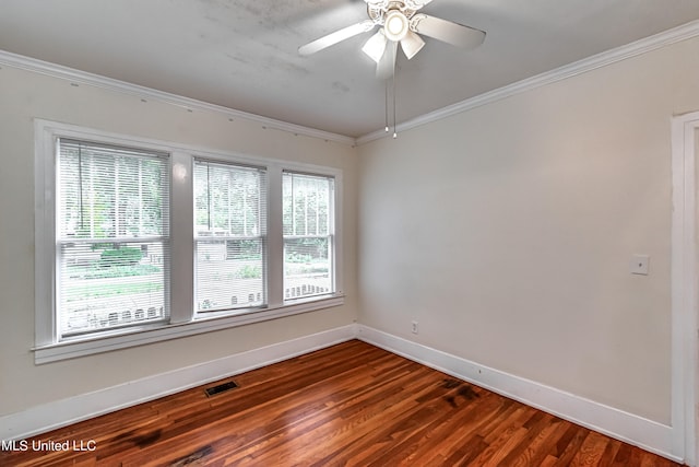 unfurnished room with ornamental molding, dark wood-type flooring, and ceiling fan