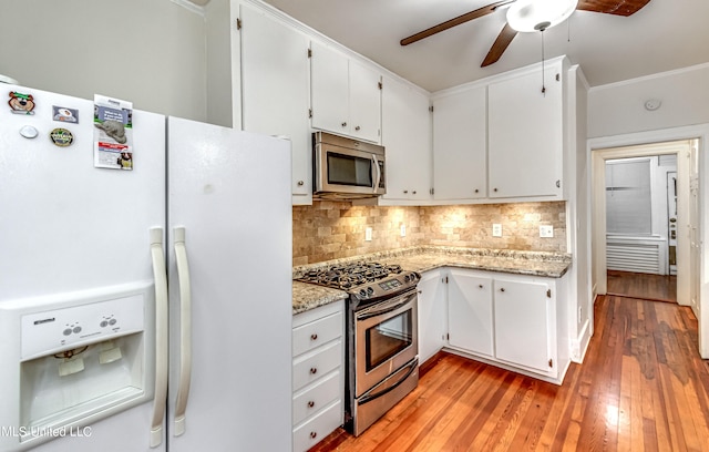 kitchen with ceiling fan, stainless steel appliances, light wood-type flooring, and white cabinets