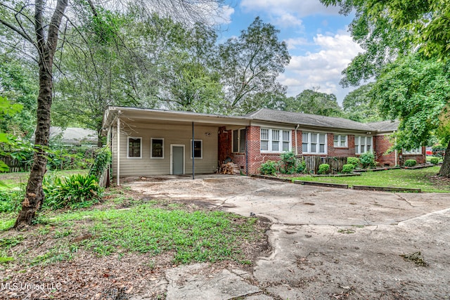 ranch-style home with a carport and a front yard