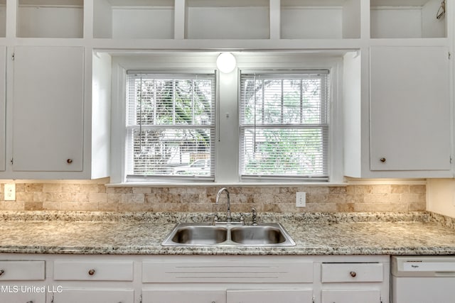 kitchen with sink, white cabinets, and dishwasher