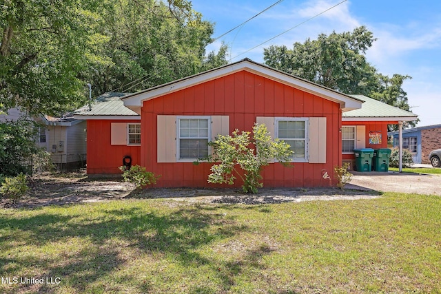 3811 16th St, Gulfport, MS 39501 - view of front of house featuring a front yard, metal roof, and board and batten siding
