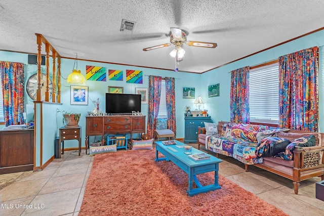 3811 16th St, Gulfport, MS 39501 - living room with crown molding, a ceiling fan, a textured ceiling, and baseboards
