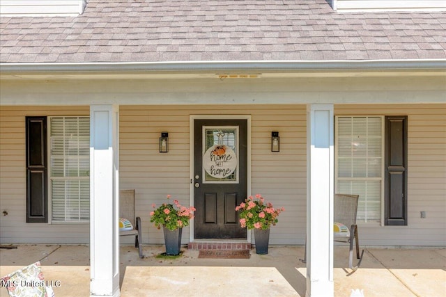 view of exterior entry with covered porch